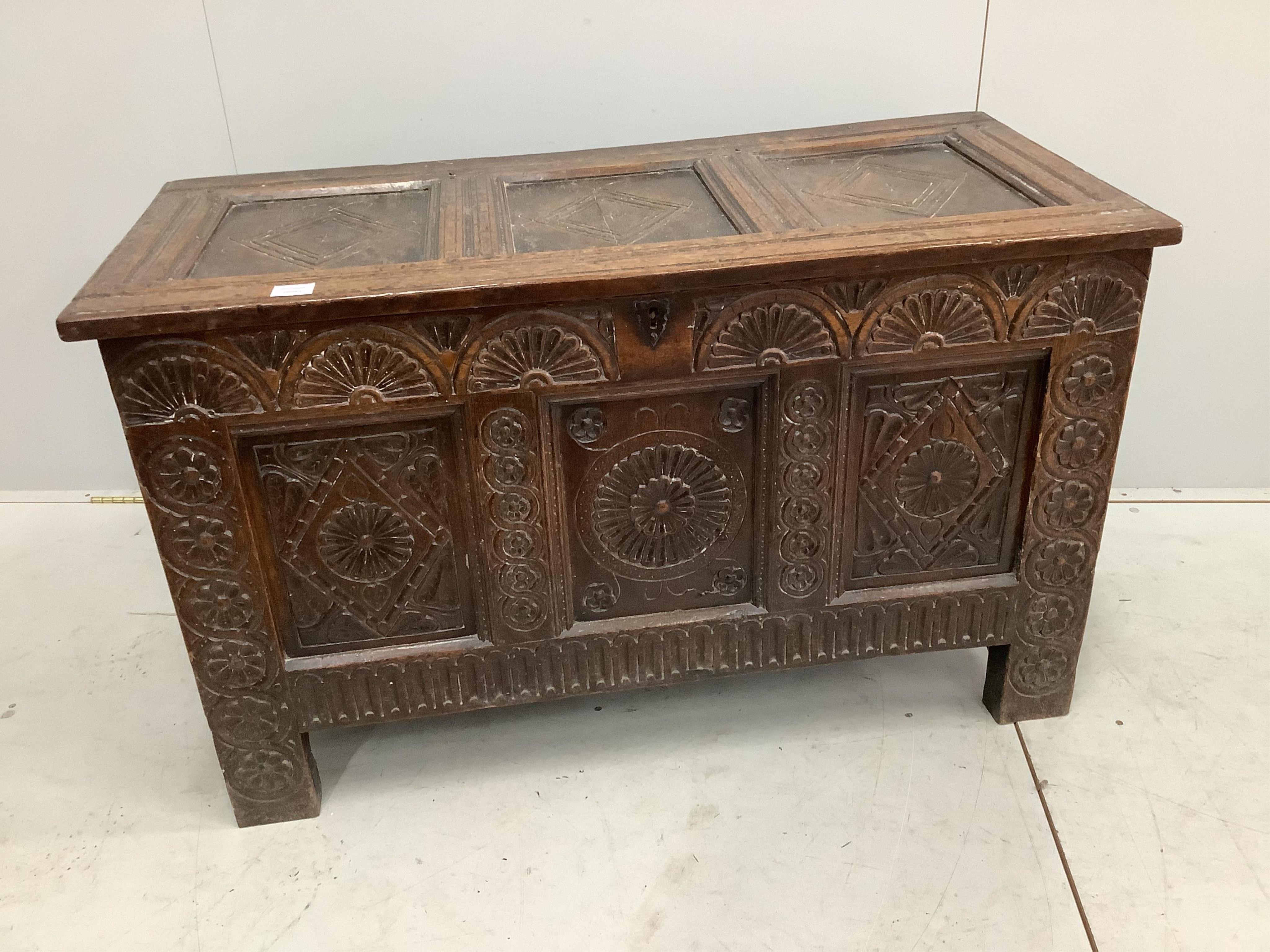 An 18th century carved oak coffer, width 117cm, depth 53cm, height 71cm. Condition - fair